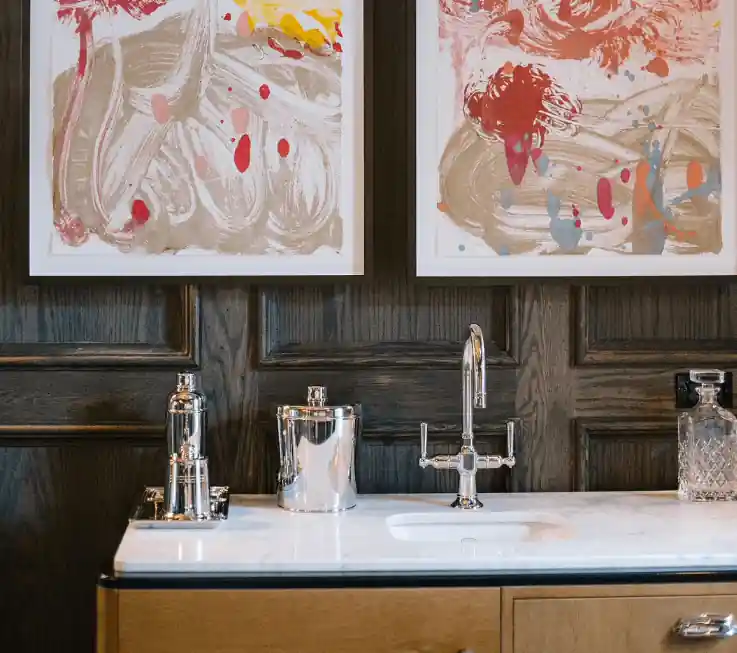 Two hand-made portrait is hanging just above the wash basin