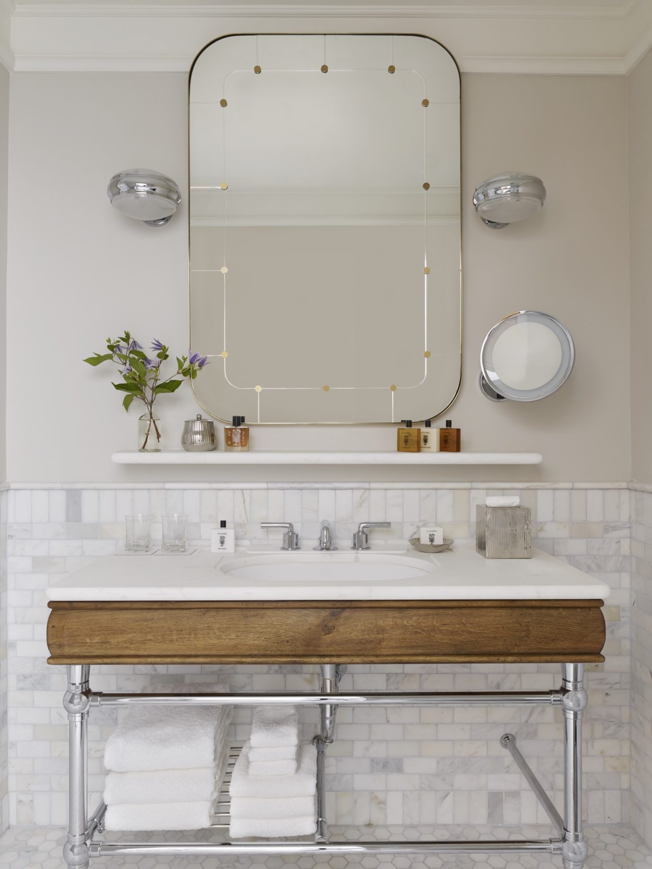A large size mirror just hanging above the wash basin